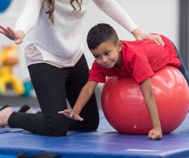 child rolling stomach on exercise ball constipation