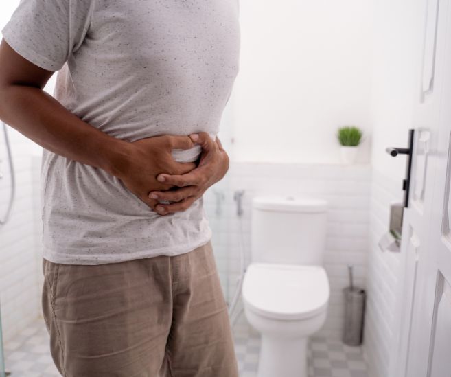 colitis and crohns disease man standing in bathroom