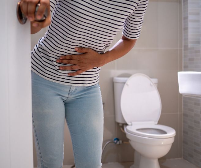 constipation woman closing bathroom door