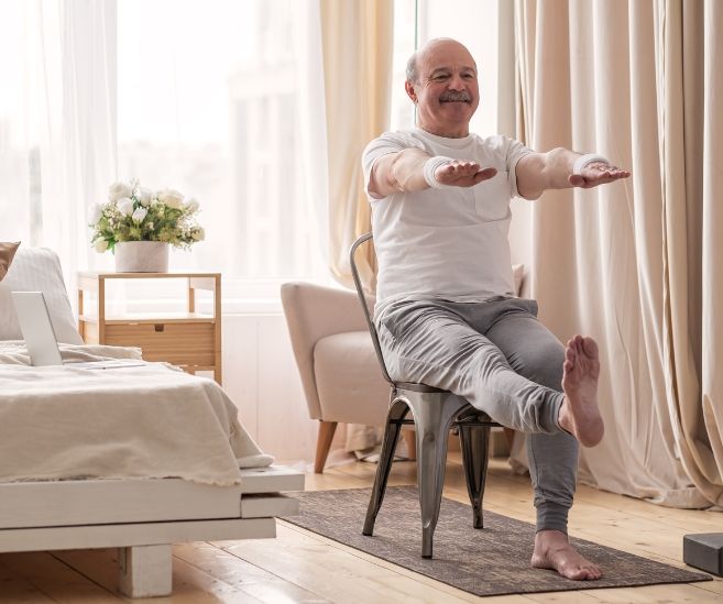 man sitting in chair balance exercises