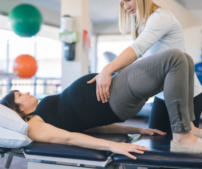 preventative care pregnant woman exercising with physical therapist
