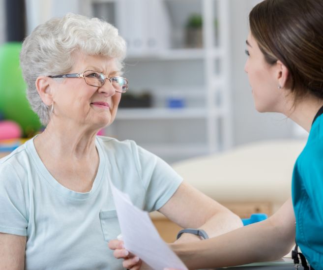 urge incontinence woman talking to physical therapist